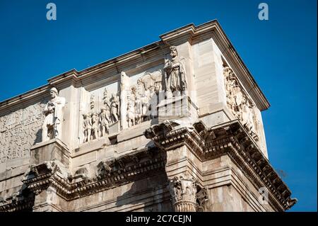 Dettagli ravvicinati di pannelli in rilievo, rilievi rotondi e fregio sulla soffitta dell'Arco di Costantino, arco trionfale a Roma Foto Stock