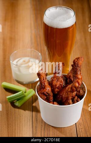 Secchio di bastoni di pollo di bufala con bastoncini di sedano, ranch e birra Foto Stock