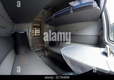 Compartimento e ormeggio con biancheria da letto in Ferrovie ucraine prima Classe trasporto a letto di un treno passeggeri Foto Stock