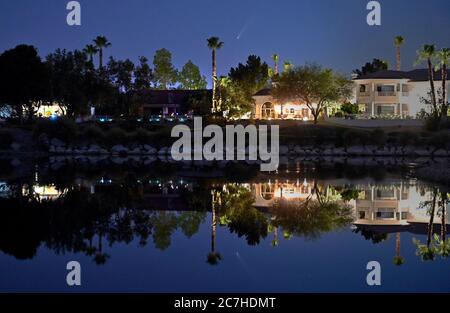 Las Vegas, Nevada, Stati Uniti. 16 luglio 2020. Il Comet NEOWISE (C/2020 F3) si vede riflettere in uno stagno di quartiere suburbano a Las Vegas, Nevada il 16 luglio 2020. Comet C/2020 F3 è stato scoperto il 27 marzo 2020 da NEOWISE, il Near Earth Object Wide-Field Infrared Survey Explorer, che è un telescopio spaziale lanciato dalla NASA nel 2009. Credit: David Becker/ZUMA Wire/Alamy Live News Foto Stock