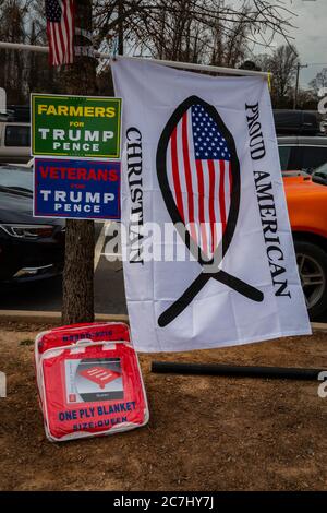 Accanto ad altri cimeli di Trump viene visualizzata una mesh del simbolo del pesce cristiano e della bandiera americana. Foto Stock