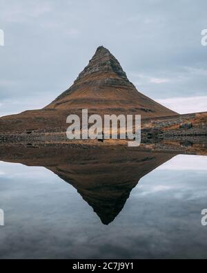 Montagna Kirkjufell vicino al Parco Nazionale Snaefellsjokull, Islanda riflesso nel lago Foto Stock