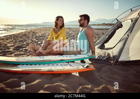 giovane coppia caucasica che si agghiacciano in spiaggia Foto Stock