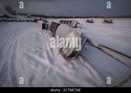 Primo piano di slitte turistiche posate su un terreno coperto di neve Foto Stock