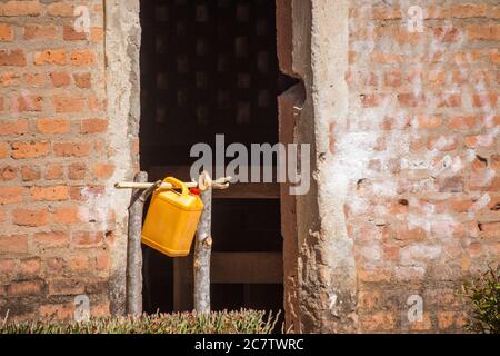 Galloni di acqua riciclati e adattati su tronchi di albero come stazioni di lavaggio delle mani per i bambini per lavare le loro mani sulle porte della classe. Noto anche come tippy tap Foto Stock