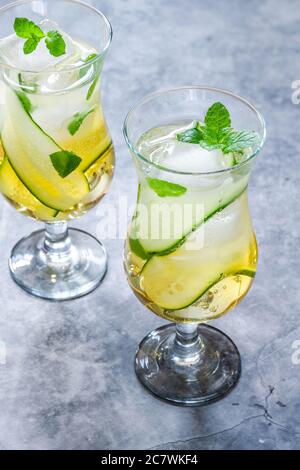 Coda di mocktail con succo di mela e di sambuco con cetrioli, menta e cubetti di ghiaccio - rinfrescante bevanda analcolica estiva Foto Stock