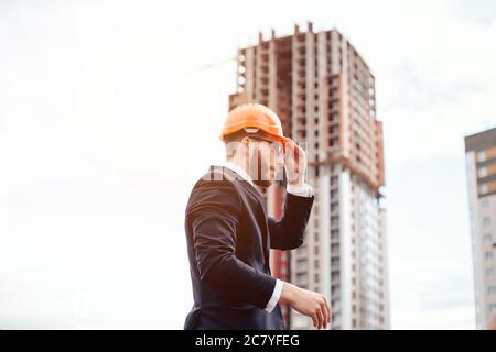 Male contractor or civil engineer looking at the building project on progress Stock Photo