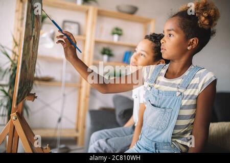 Carino Bambini ragazza ragazzo e pittura insieme. Educazione, arte, il divertimento e la creatività del concetto. Foto Stock