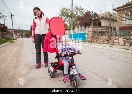 Trebujeni / Moldavia - 15 maggio 2020: Bambina che passeggiava con la madre attraverso una città turistica in Moldavia Foto Stock