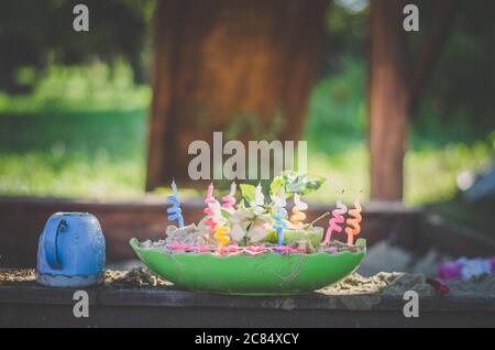 torta di compleanno per bambini fatta di sabbia nel parco giochi Foto Stock