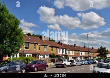 Fila di case a schiera con auto parcheggiate di fronte lungo la strada, Horfield, Bristol Foto Stock