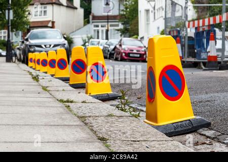 Immagine dal basso punto di vista di nessun cono di parcheggio sul lato di una strada residenziale a causa di lavori stradali, Londra, Regno Unito Foto Stock