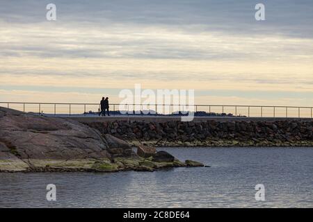 L'argine di Helsinki nel distrinto di Merisatama. Coppia a piedi lungo le isole della città. Foto Stock