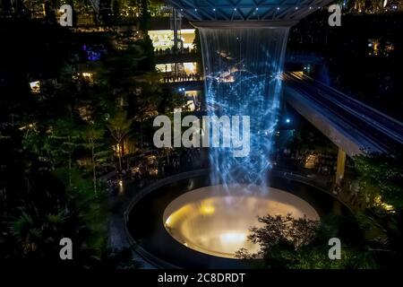 SINGAPORE - 3 MARZO 2020: Cascata al GIOIELLO del centro commerciale al terminal 4 dell'aeroporto changi di singapore in serata. Spettacolo di luci sull'acqua Foto Stock