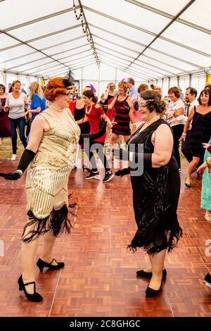 Donne vestite in costume d'epoca Danza alla Grande Fiera di Gatsby, Bexhill on Sea, East Sussex, UK Foto Stock