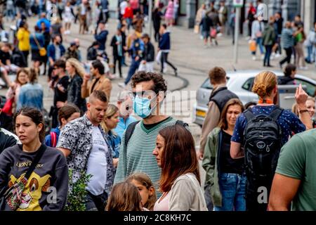 Amsterdam, Paesi Bassi. 25 luglio 2020. Un uomo che indossa una maschera facciale come precauzione contro la diffusione del virus covid 19. Affollata di turisti che fanno shopping per le strade e la diga piena di visitatori con traffico di sola andata nella Kalverstraat, si cerca di tenere a un metro e mezzo di distanza, ma è difficile tra le minacce del coronavirus. Credit: SOPA Images Limited/Alamy Live News Foto Stock