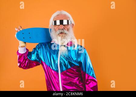Uomo anziano con sguardo eccentrico - uomo di 60 anni che ha divertimento, ritratto su sfondo colorato, concetti circa la gente anziana giovanile e stile di vita Foto Stock