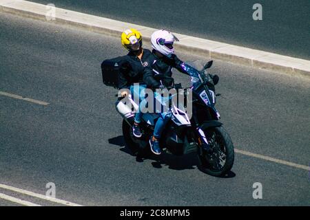 Lisbona Portogallo 25 luglio 2020 Vista di persone non identificate che guidano una motocicletta nelle strade di Lisbona, la città costiera collinare capitale del Portogallo An Foto Stock