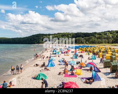 Rügen an der Ostsee mit vielen Touristen am Badestrand während des Urlaubs in den Sommerferien, Strandkörbe mit Badegäste Foto Stock