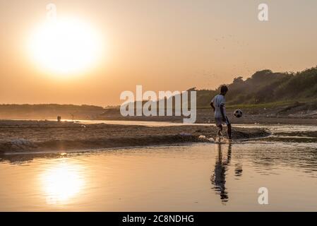 Ragazzi birmani che giocano a calcio sul fiume Irrawaddy a Pakokku, Myanmar Foto Stock