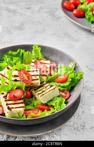 Insalata con formaggio alla griglia, pomodoro e salsa di vino Foto Stock