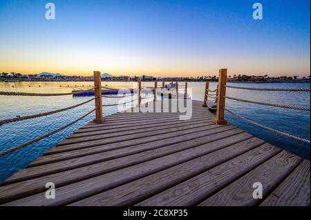 Molo di legno sul Mar Rosso a Hurghada al tramonto, Egitto - destinazione di viaggio in Africa Foto Stock