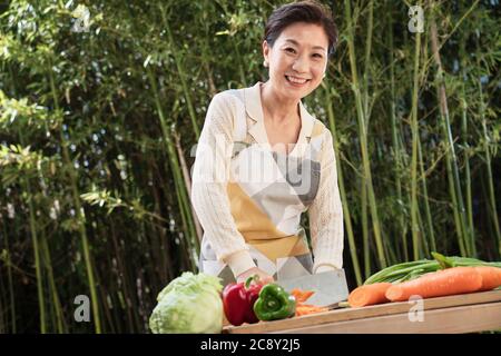 Il cortile tritare verdure in donne di mezza vita Foto Stock