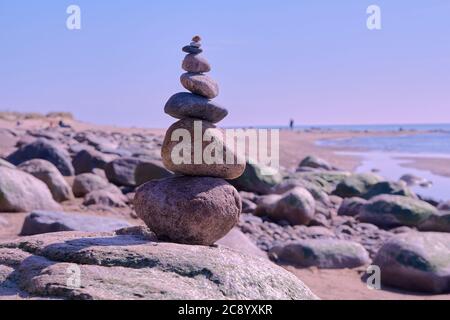 Zen equilibrio di pietre a riva rocciosa del Mar Baltico in giornata di sole Foto Stock