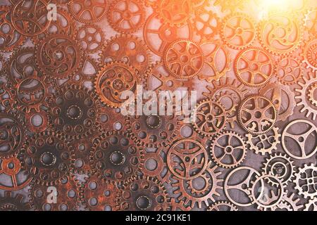 Ingranaggi, sfondo astratto con luce solare, un sacco di piccoli ingranaggi arrugginiti, Steampunk Foto Stock