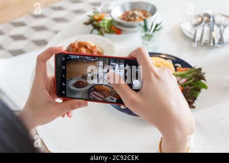 12 luglio 2020 - Khaoyai Thailandia : mani con il telefono primo piano immagini della colazione. Foto Stock