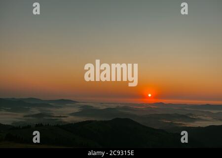 alba in alto sulle montagne sopra le nuvole Foto Stock