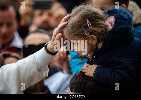 Papa Francesco benedice un bambino durante la sua udienza generale settimanale in Piazza San Pietro in Vaticano. Foto Stock