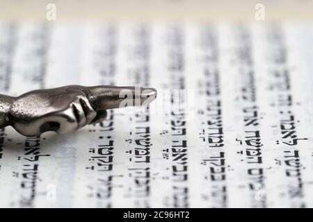 Un puntatore rituale ebraico Yad argento su una Torah. Francia. Foto Stock