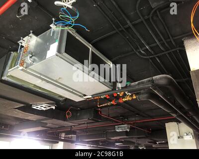 Installazione dell'unità di gestione dell'aria o dell'unità bobina della ventola in loft ufficio Foto Stock