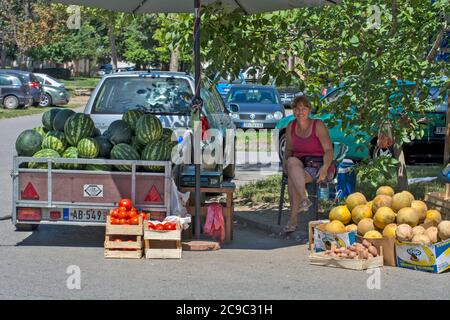 Zrenjanin, Serbia, luglio 29,2020.Efficient e vendita rapida di cocomeri sulla strada vicino a edifici con un sacco di abitanti.in aggiunta al cocomero Foto Stock