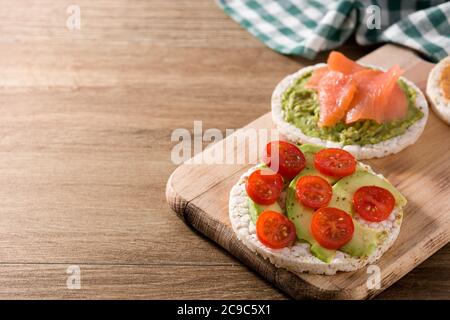 Assortimento di ingredienti su torte di riso soffiato su tavolo di legno Foto Stock