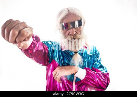 Nonno alla moda in posa con divertenti abiti futuristici. Ritratti dell'uomo anziano su sfondo colorato Foto Stock