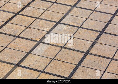 L'area posata da lastre di pavimentazione quadrate di nero e una piastrella beige. Foto Stock