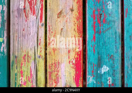 Tavole di legno colorate d'epoca con vernice fessurata dagli agenti atmosferici. Sfondo retrò con vecchie tavole di legno di diversi colori. Foto Stock