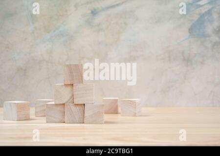 Cubetti giocattolo di legno su tavolo di legno e sfondo grigio Foto Stock