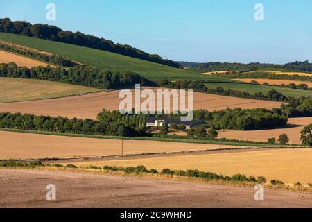 Tipico cortile situato nella campagna inglese. La valle del Mey nell'Hampshire in una giornata estiva limpida. Cieli blu con nuvole piccole per rovinare la vista. Foto Stock