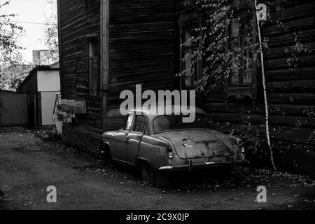 Auto d'epoca nei pressi della leuchia di legno a Tomsk, Siberia. Foto in bianco e nero. Foto Stock