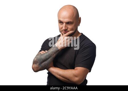 Foto di uomo calvo perplesso in camicia nera su sfondo bianco Foto Stock