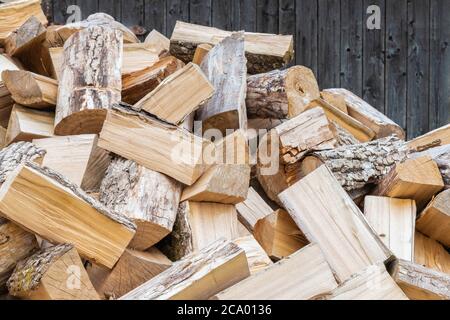 Legna da ardere secca tagliata di fondo. Preparazione di legna da ardere per l'inverno. Rustico accogliente legna da ardere sfondo. Concetto naturale, organico Foto Stock