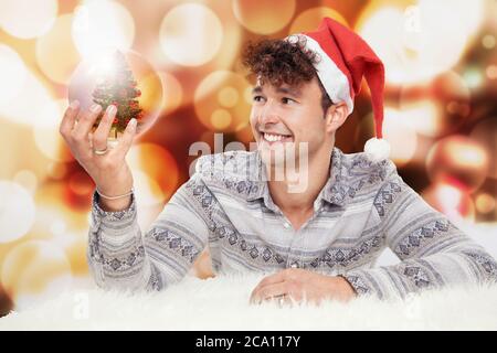 Uomo con una sfera di vetro di natale Foto Stock