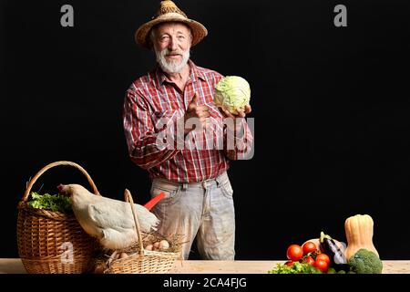 L'uomo anziano del villaggio proveniva dal mercato agricolo, dove comprava uova, galline, un sacco di cetrioli, pomodori, cavolo e qualche altra verdura fresca, andando a co Foto Stock