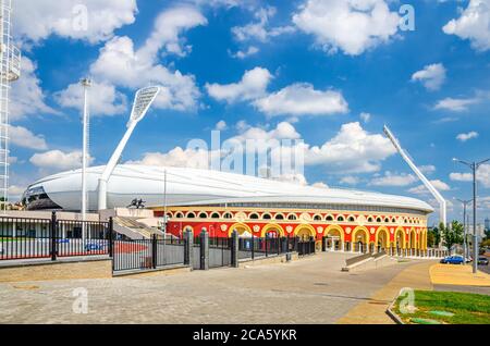 Minsk, Bielorussia, 26 luglio 2020: Stadio olimpico nazionale Dinamo con piloni illuminati torri nel centro storico della città di Minsk, cielo blu nuvole bianche nella soleggiata giornata estiva Foto Stock