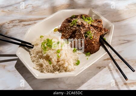 Piatto vietnamita di manzo al sesamo grigliato con un lato di riso bianco Foto Stock