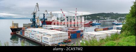 Vista panoramica del porto commerciale marittimo, gru scarico nave da carico container russo Sevmorput, navi da pesca al molo, terminal container Foto Stock
