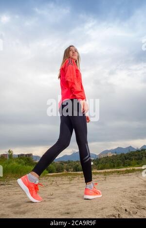 Fitness donna runner rilassante dopo la corsa in città, ragazza che guarda e godendo di vista Foto Stock